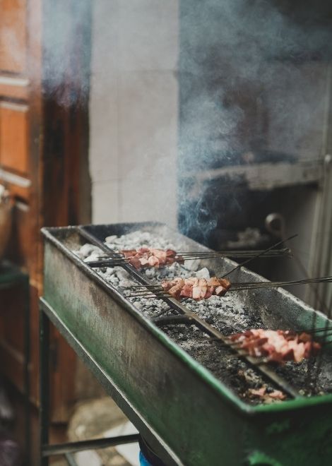 Sizzling chicken skewers cooked over hot charcoal